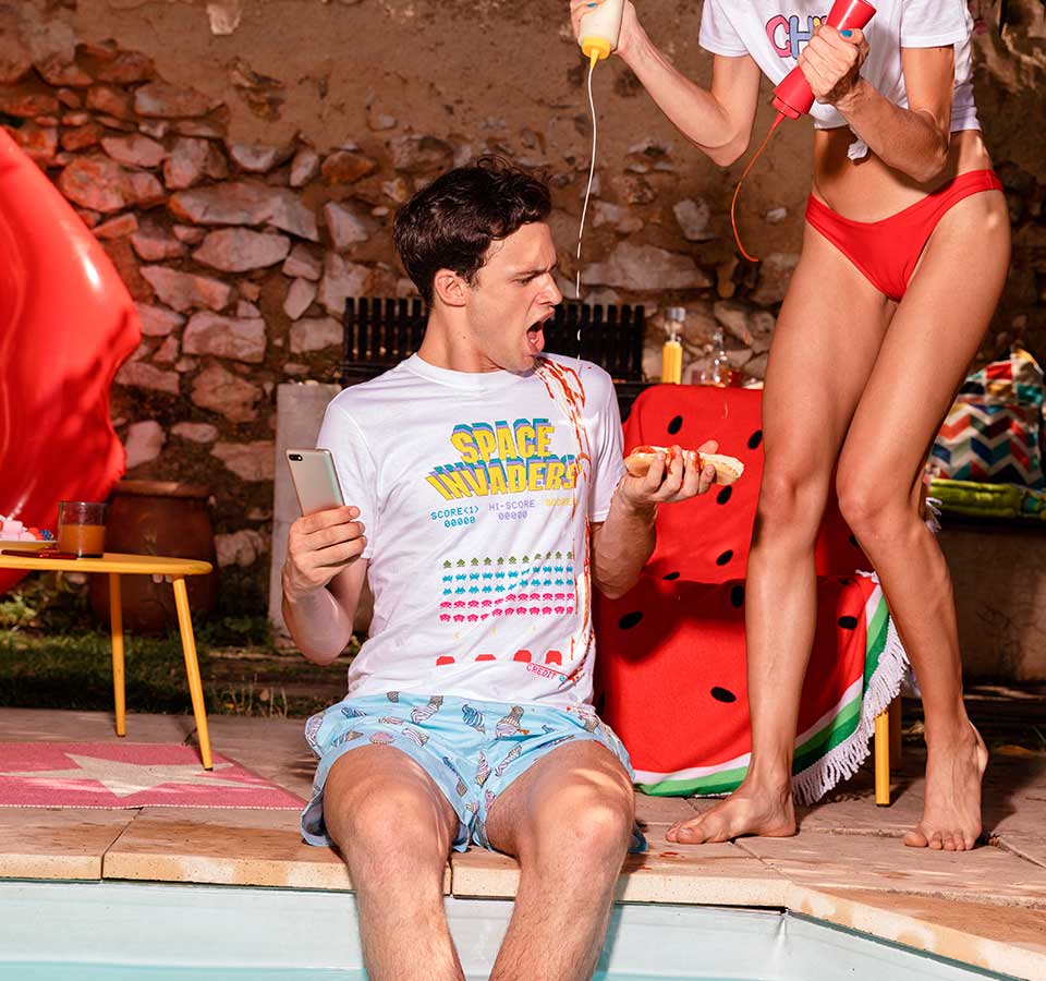 a woman and a guy playing next to a pool